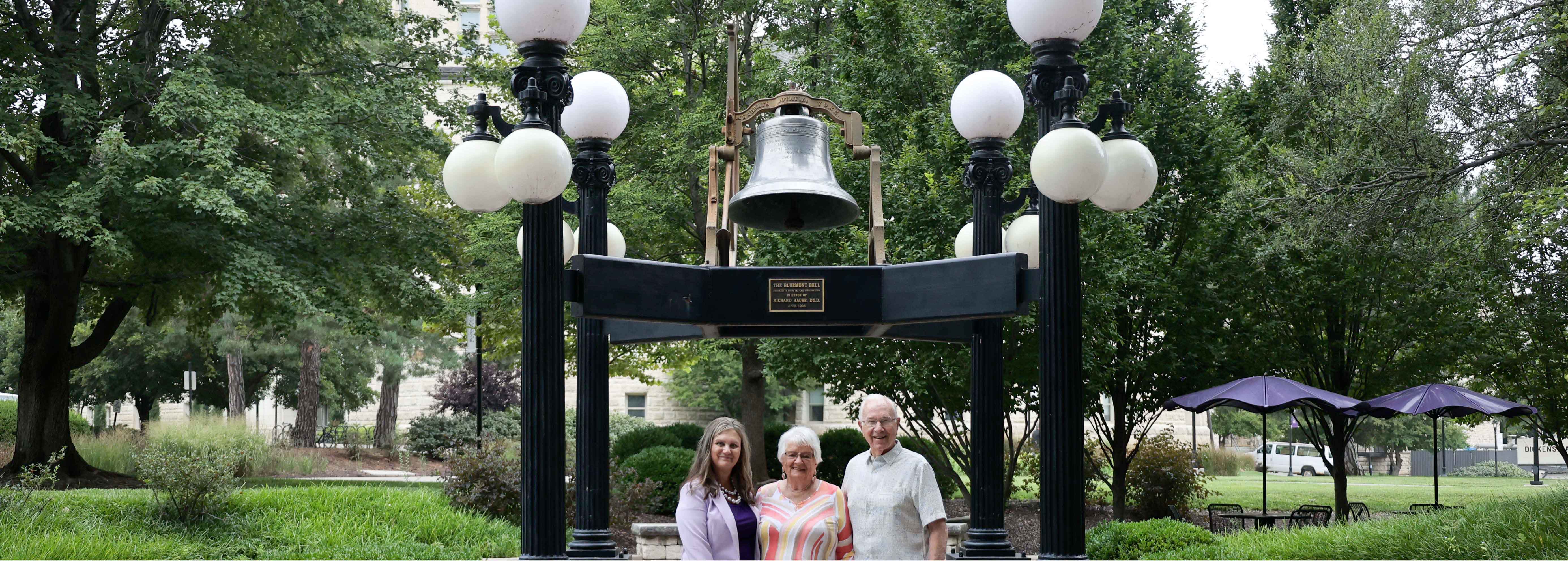 Dean Mercer & the Galles standing in front of the bell